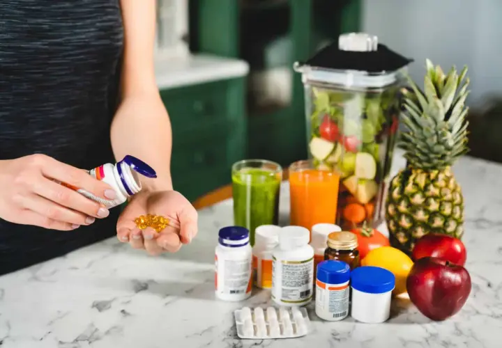Persona optimiza su salud con biohacking suplementos y batidos de frutas.